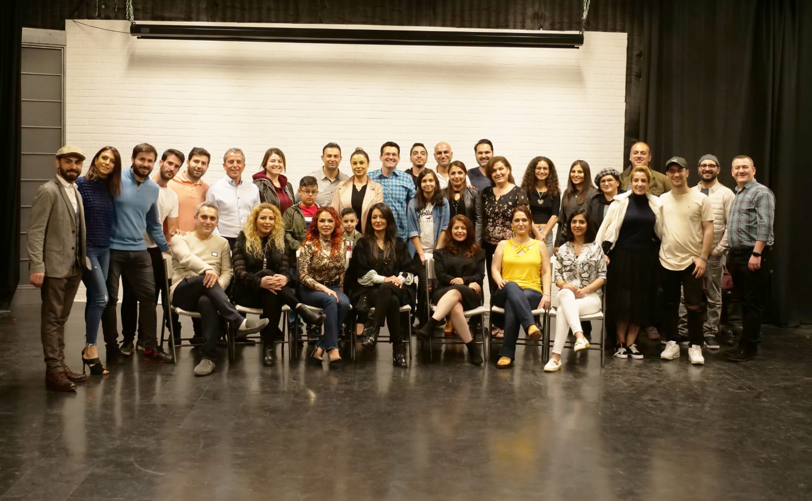 Creative team and collaborators on a production stage